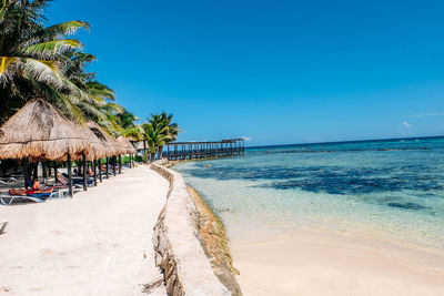 Scenic view of beach against blue sky