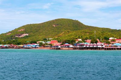 Scenic view of sea and buildings against sky