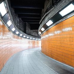 Empty walkway in illuminated city