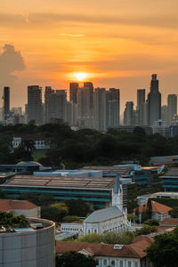 High angle view of buildings in city during sunset