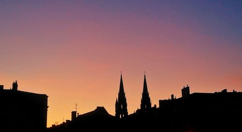 Silhouette of city at sunset