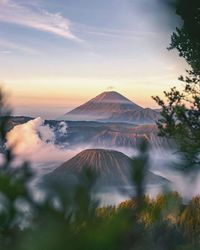 Scenic view of volcanic crater against sky during sunset