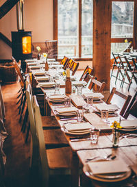 Plates and drinking glasses arranged on restaurant tables