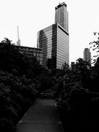 Modern buildings in city against clear sky