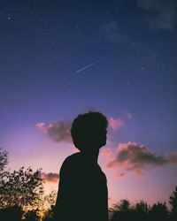 Silhouette man standing against sky at sunset