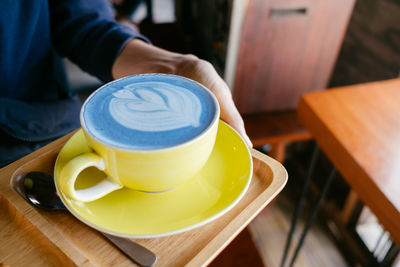 Midsection of coffee cup on table