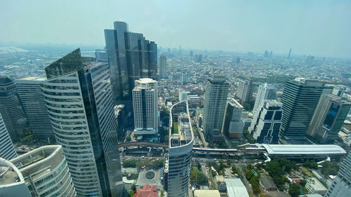 High angle view of buildings in city against sky