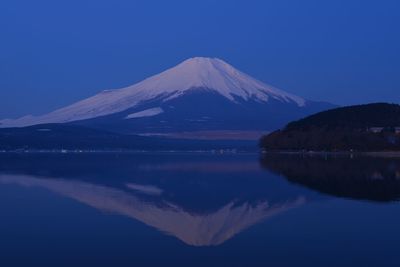 Reflection of mt fuji on calm lake at dusk