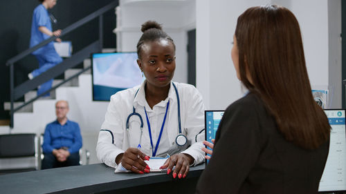 Portrait of female doctor examining x-ray in office