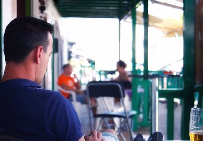 Rear view of man using mobile phone