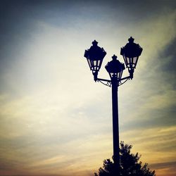 Low angle view of silhouette trees against sky at dusk