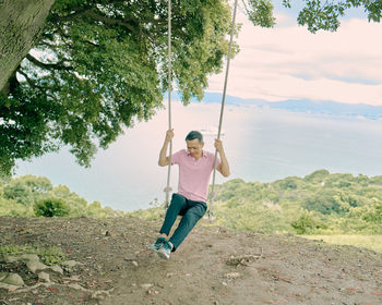 Full length of woman on swing