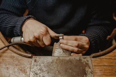 Midsection of man working on table