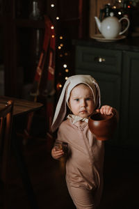 Toddler baby girl in funny hat with ears having fun