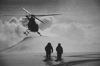 Helicopter over people standing on snowy field
