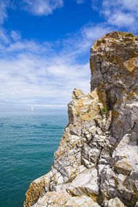 Rock formation amidst sea against sky