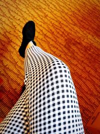 Low section of woman standing on tiled floor