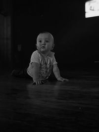 Cute boy looking away on floor at home