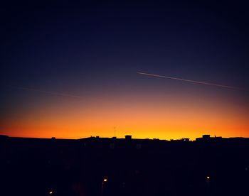 Silhouette landscape against sky during sunset