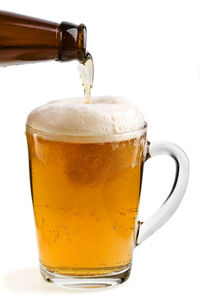 Close-up of beer glass against white background