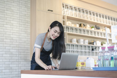 Young woman using mobile phone in office