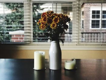 Close-up of flower vase on window sill
