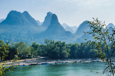 Scenic view of lake and mountains against sky