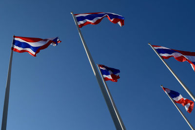 Low angle view of flags flag against sky