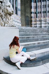 Woman sitting on staircase