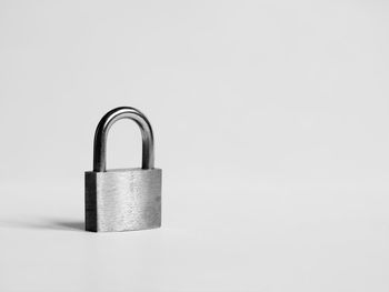 Close-up of padlocks against white background