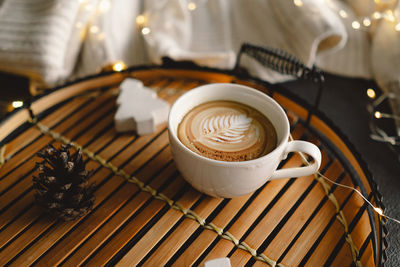 Christmas cup of coffee with sweater and christmas decorations.