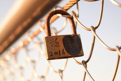 Close-up of love padlock hanging on metal