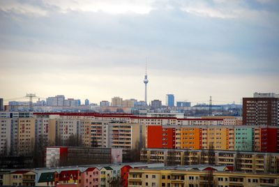 Buildings against cloudy sky