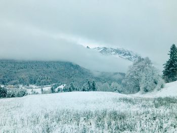 Scenic view of snow covered landscape against sky