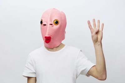 Rear view of woman wearing mask against white background