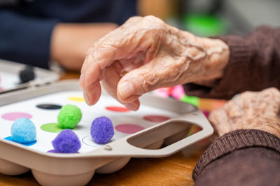 Cropped hand of person preparing food