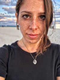 Close-up portrait of young woman at beach