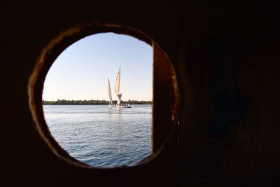 Boats sailing in sea against sky