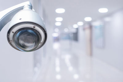 Low angle view of illuminated lighting equipment hanging from ceiling