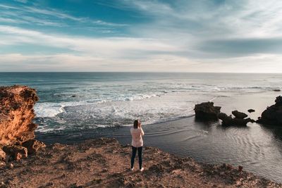 Rear view of man standing on beach