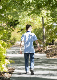 Full length of young man walking on boardwalk