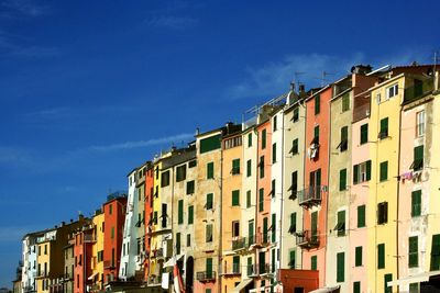 Low angle view of residential buildings against blue sky