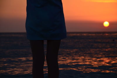 Man standing on beach during sunset