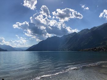 Scenic view of sea and mountains against sky