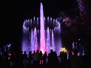 Low angle view of firework display at night