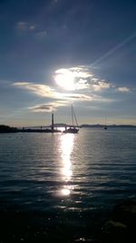 Boats sailing in sea against sky during sunset