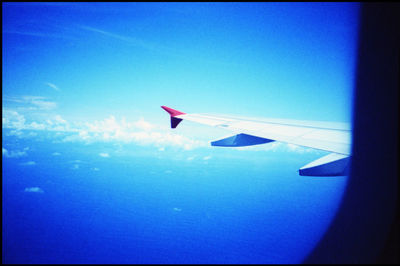 Close-up of airplane wing against clear blue sky