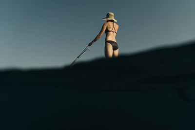 A young woman enjoys a standup paddle board on lost lake in oregon.