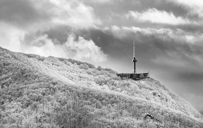 Lighthouse on mountain against sky