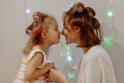 Side view of mother and daughter